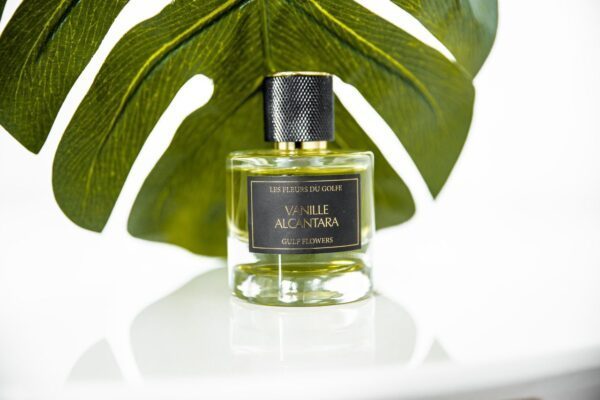 Une photo du parfum Vanille Alcantara. Le fond est une longue feuille de plante verte.